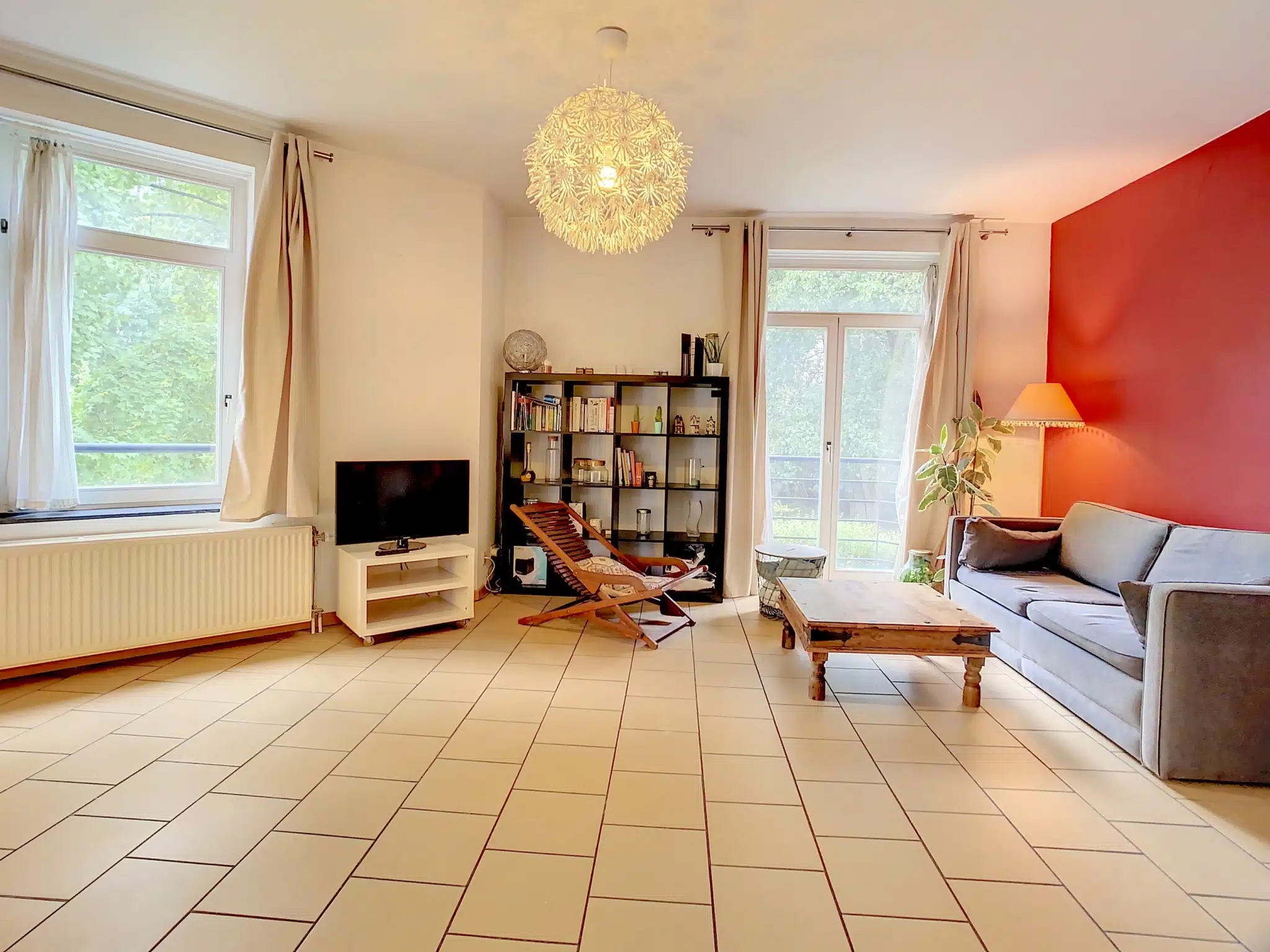 Comfortable living room with red wall and modern elements Living room - Magnificent 2 bedroom apartment - Near Place van Meenen - Ixelles