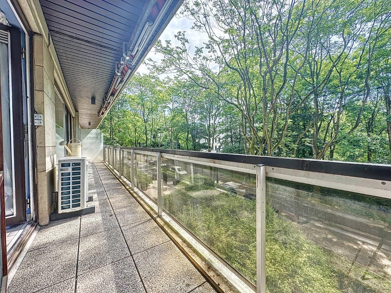 Balcon moderne avec vue verdoyante et espace détente, idéal pour relaxer et profiter de la nature.