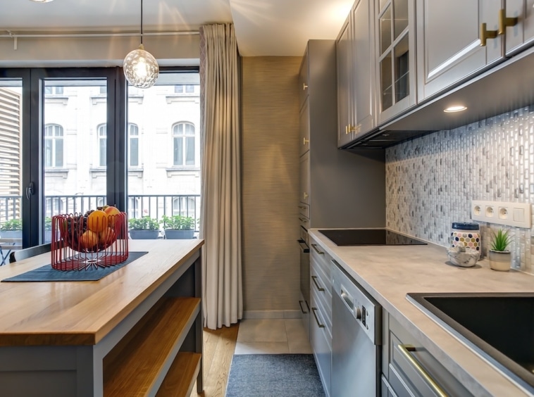 Cuisine moderne avec îlot en bois, éclairage naturel, design épuré et décoration colorée.