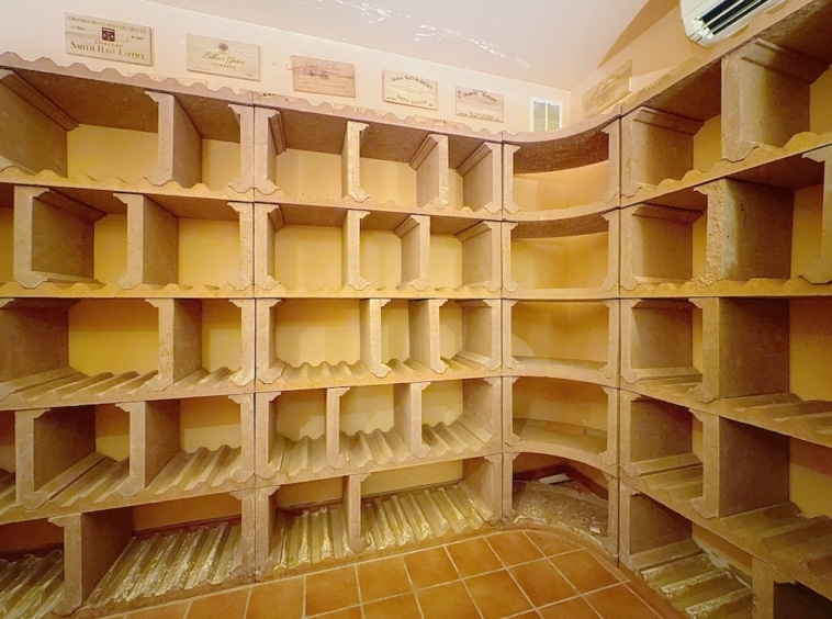 Cave à vin moderne avec étagères cubiques, architecture unique et ambiance chaleureuse.