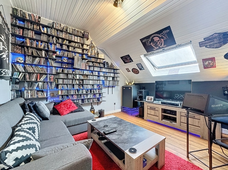 Salon contemporain avec collection musicale, mobilier moderne, éclairage bleu et décoration éclectique.