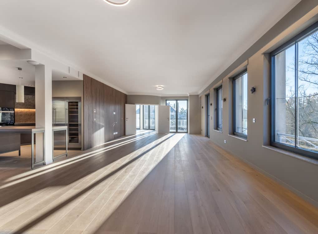 Salon lumineux avec vue panoramique, cuisine moderne épurée, ambiance élégante et relaxante.