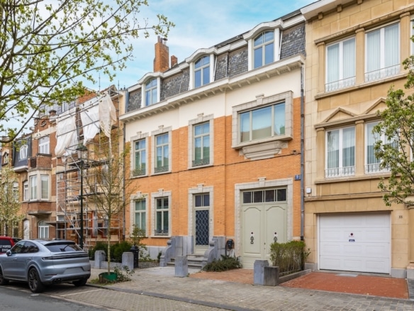 Elegant residential street with brick buildings, parking and friendly atmosphere.