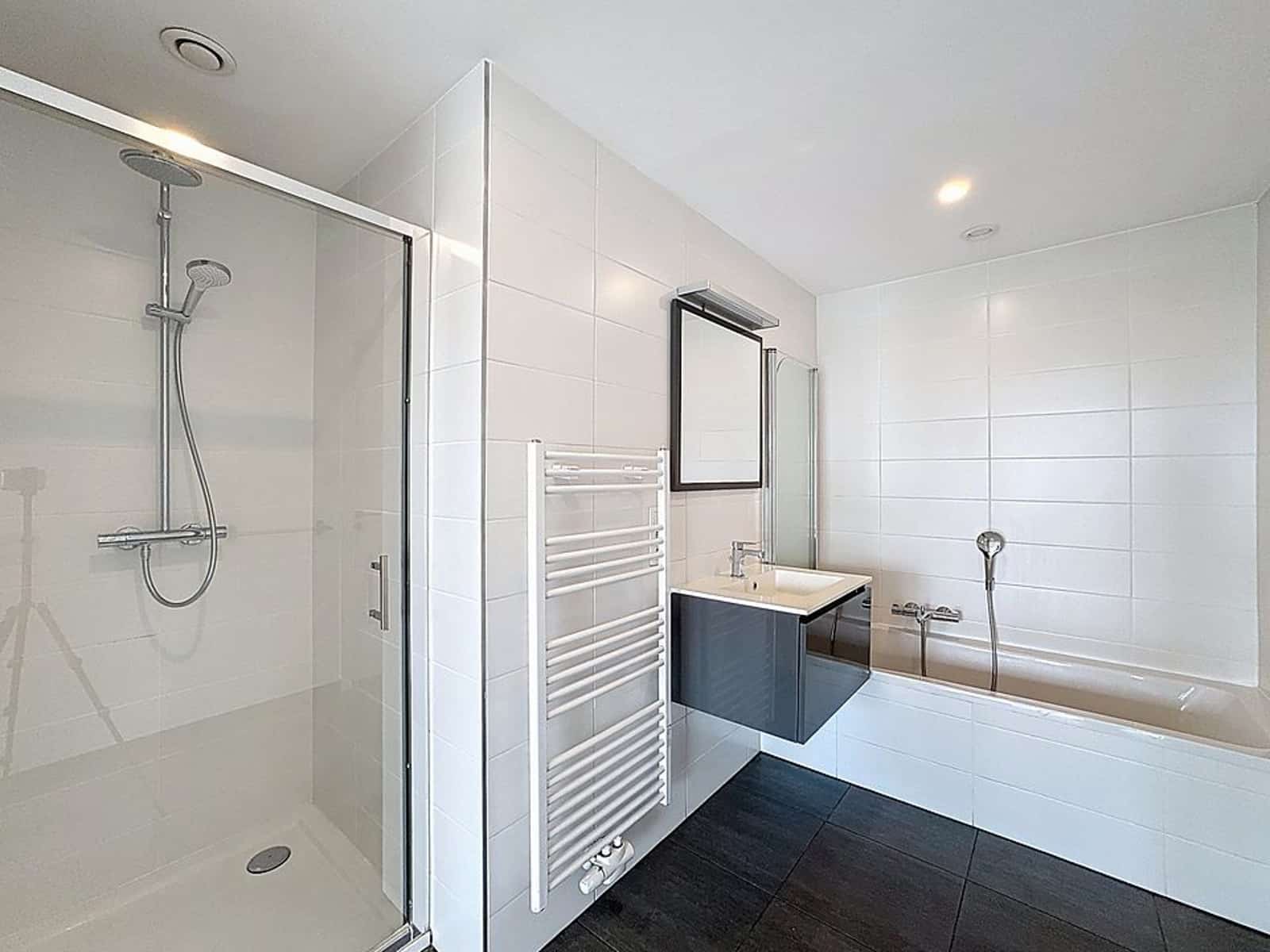 Bathroom with shower and bath - You Real Estate Agency Bright bathroom with glass-enclosed Italian shower, sunken bathtub and wall-hung washbasin