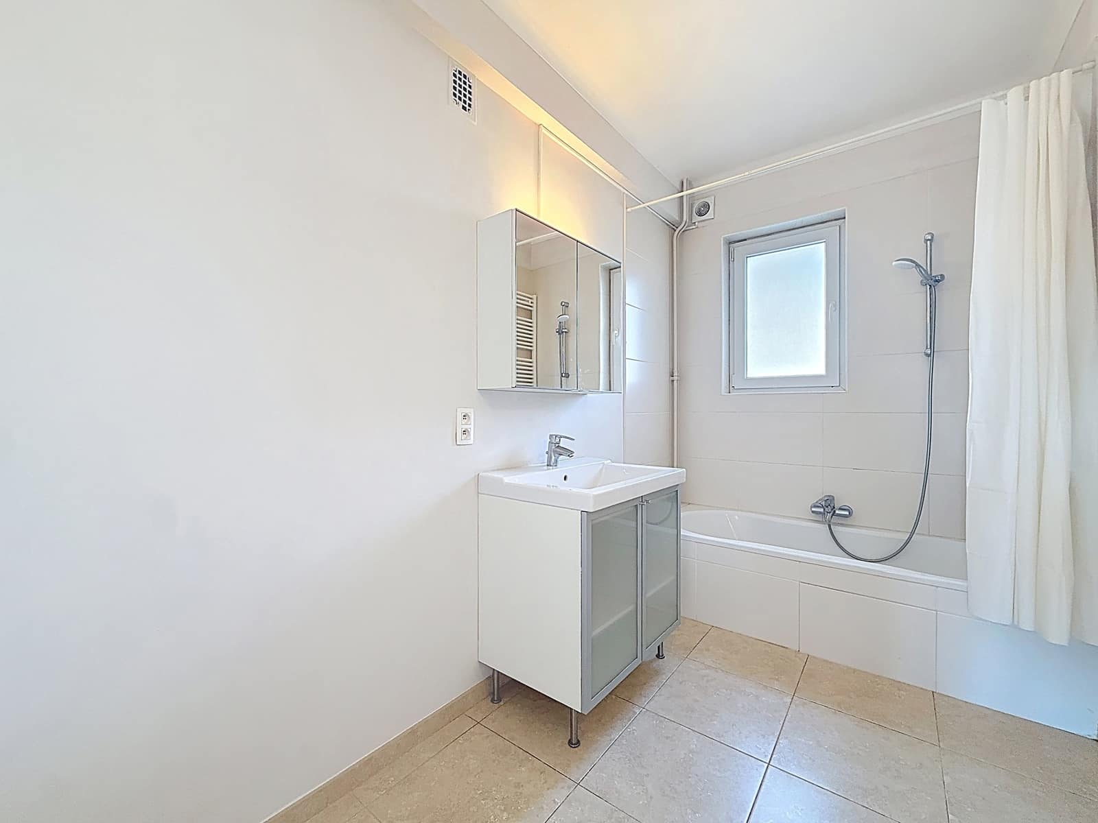 Sleek bathroom with bath - You Real Estate Agency Bright modern bathroom with bath, vanity unit and frosted window