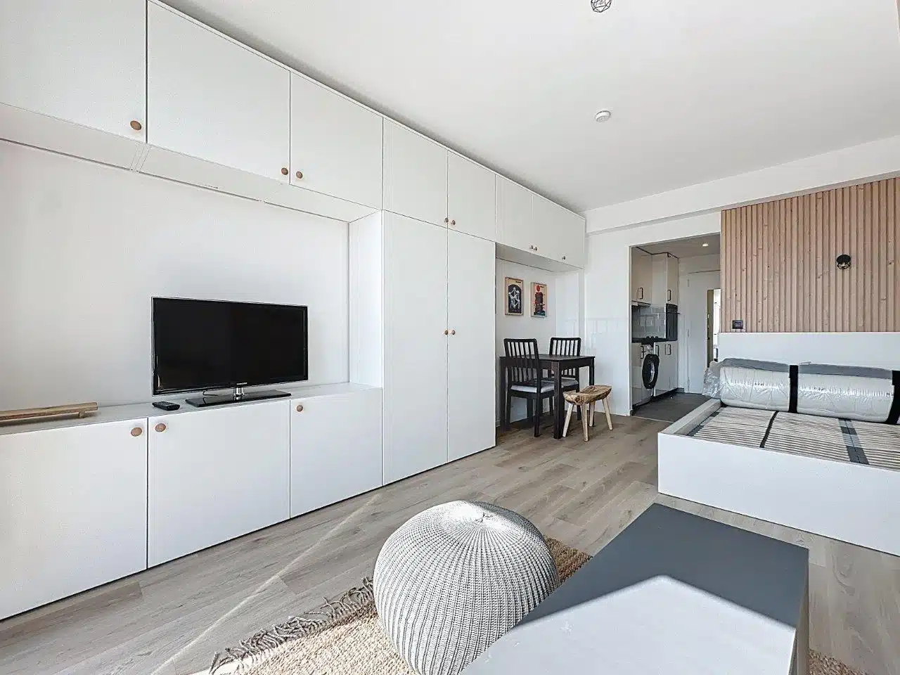 Bright Studio with Storage - You Real Estate Agency Bright studio with living room, built-in storage, dining area and open kitchen.