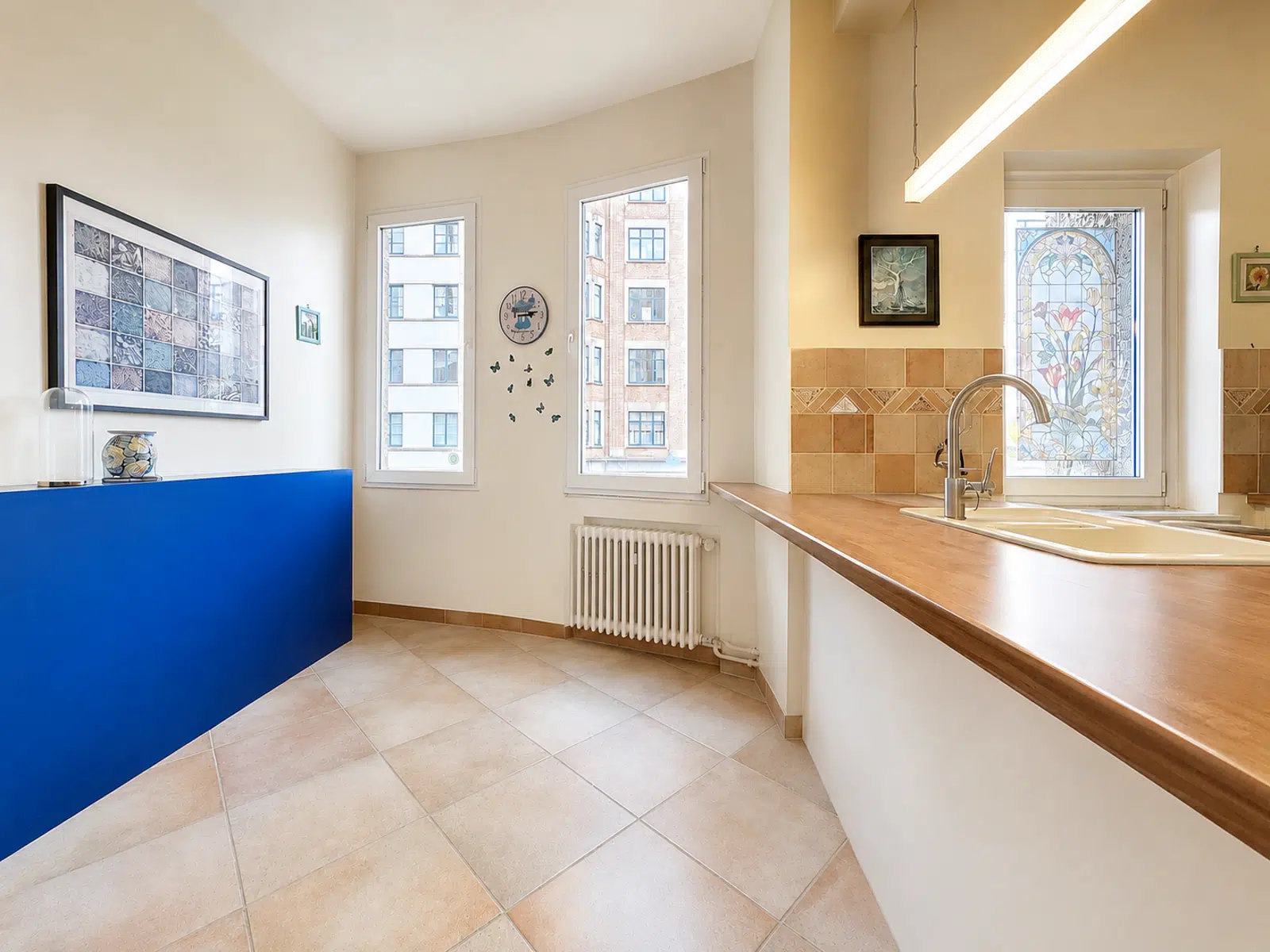 Bright kitchen with bar - You Real Estate Agency Bright apartment kitchen with bar, sink, windows and modern decor.