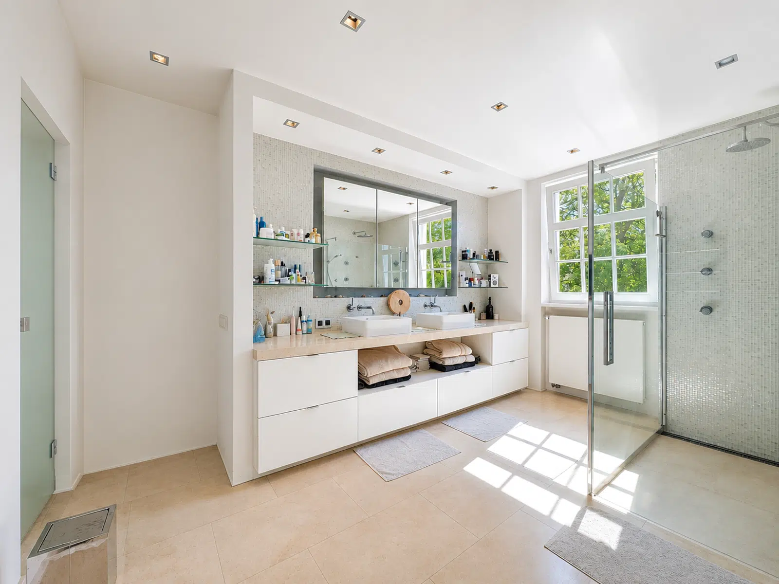 Salle de Bain avec Double Vasque – You Real Estate Agency Salle de bain moderne avec double vasque et douche vitrée.