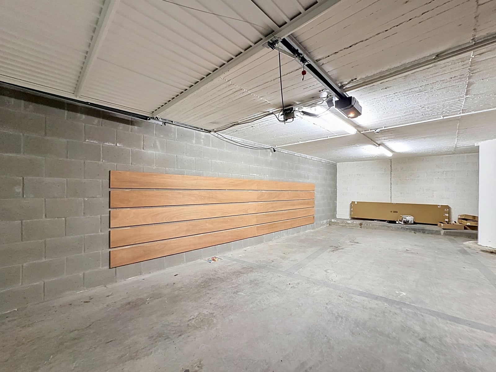 whise photo 3 Industrial basement/garage with gray concrete block walls and long horizontal wooden slats mounted on the left wall