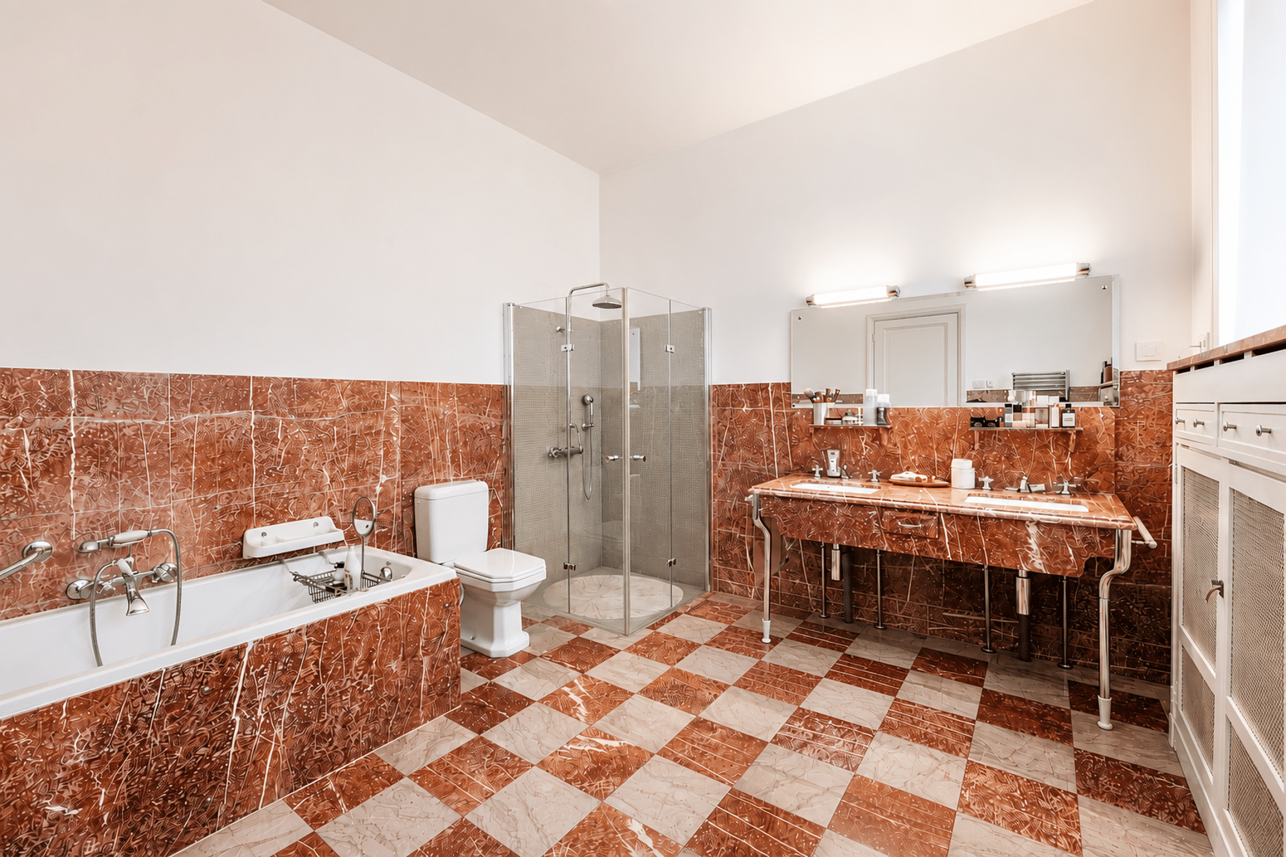 whise photo 14 Bathroom with red marble tiling, a glass-enclosed shower, a toilet, a bathtub, and a long red-marble vanity with a large mirror.
