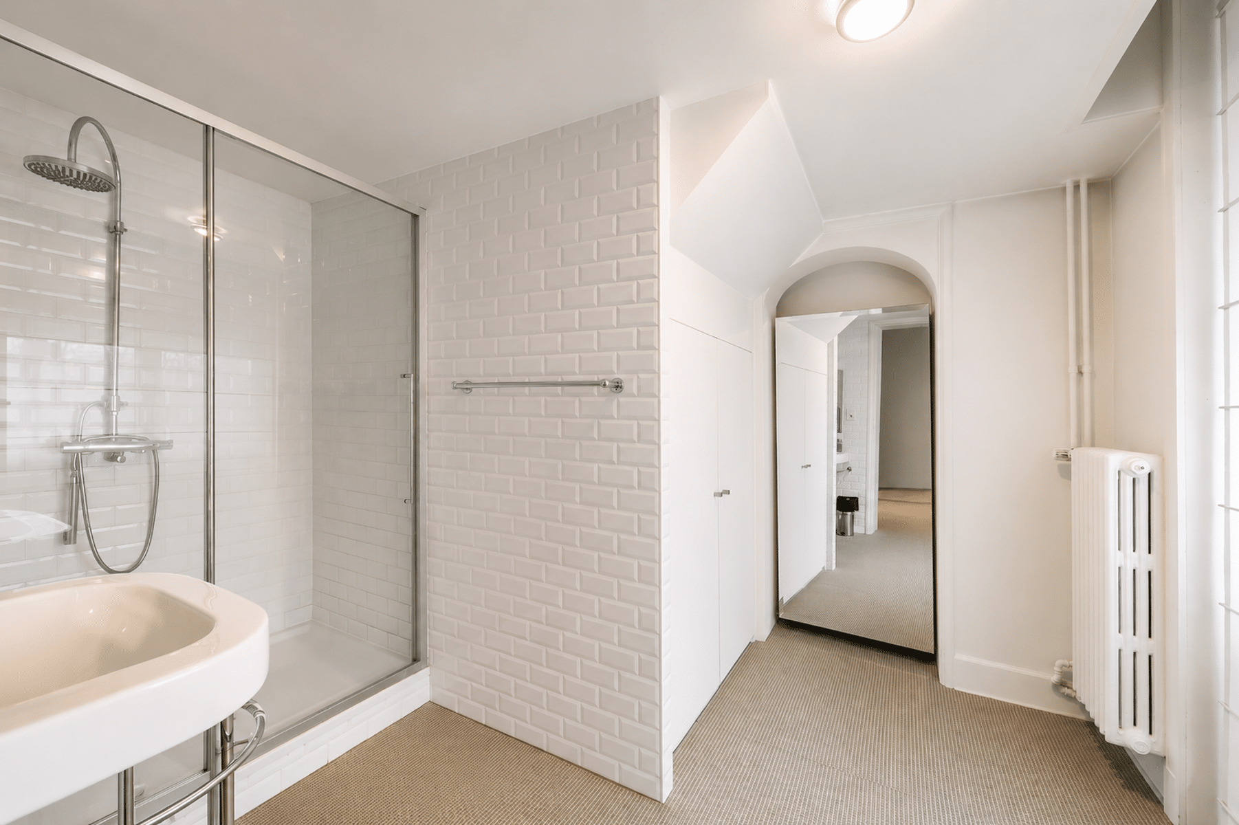 whise photo 19 Glass-walled shower with a rainfall head, white subway tiles, and a curved porcelain sink in the foreground.