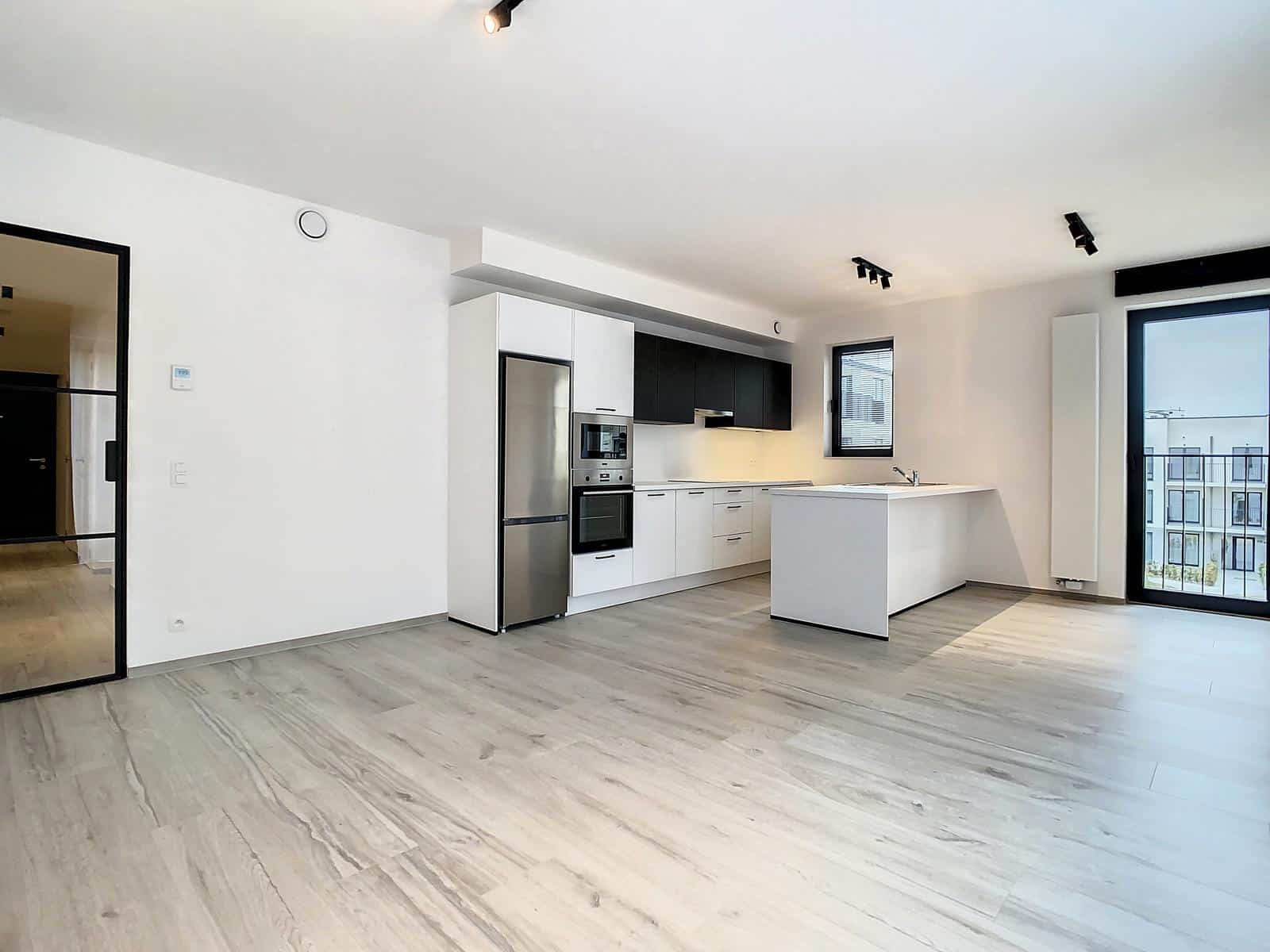 Bright living room with open kitchen - You Real Estate Agency Modern apartment with open kitchen, bright living room and balcony.