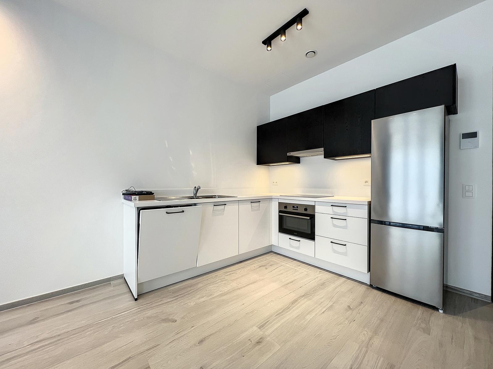 whise photo 3 Modern L-shaped kitchen with white base cabinets, black wall cabinets, and stainless steel fridge, oven, and dishwasher.