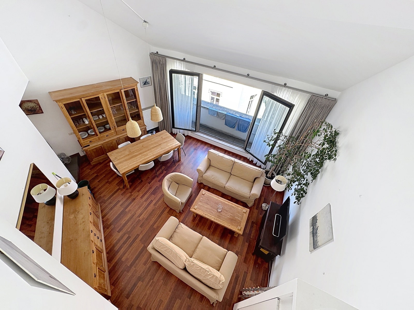 Salon Salle à Manger Lumineux – You Real Estate Agency Salon salle à manger lumineux avec parquet, hauts plafonds et balcon en appartement.