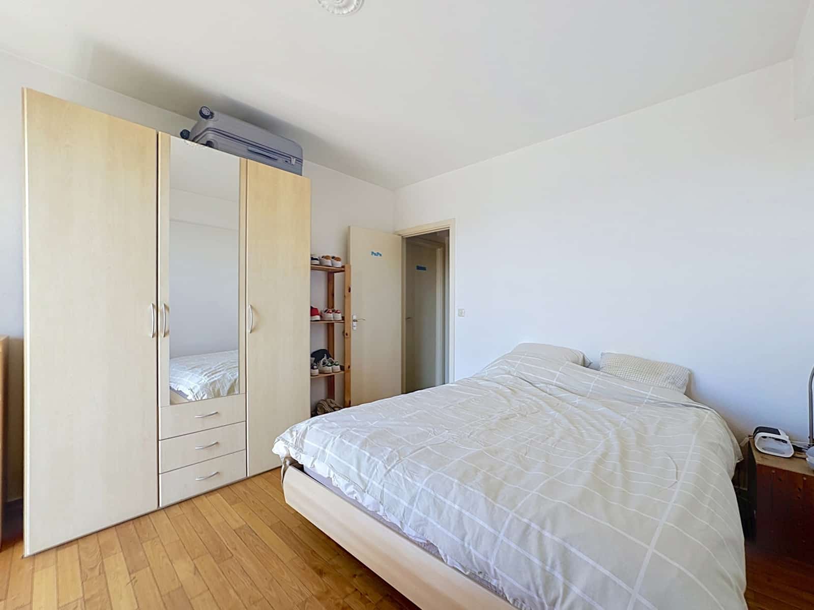whise photo 7 Bedroom with a large light-wood wardrobe, bed, and a shoe shelf beside an open door.