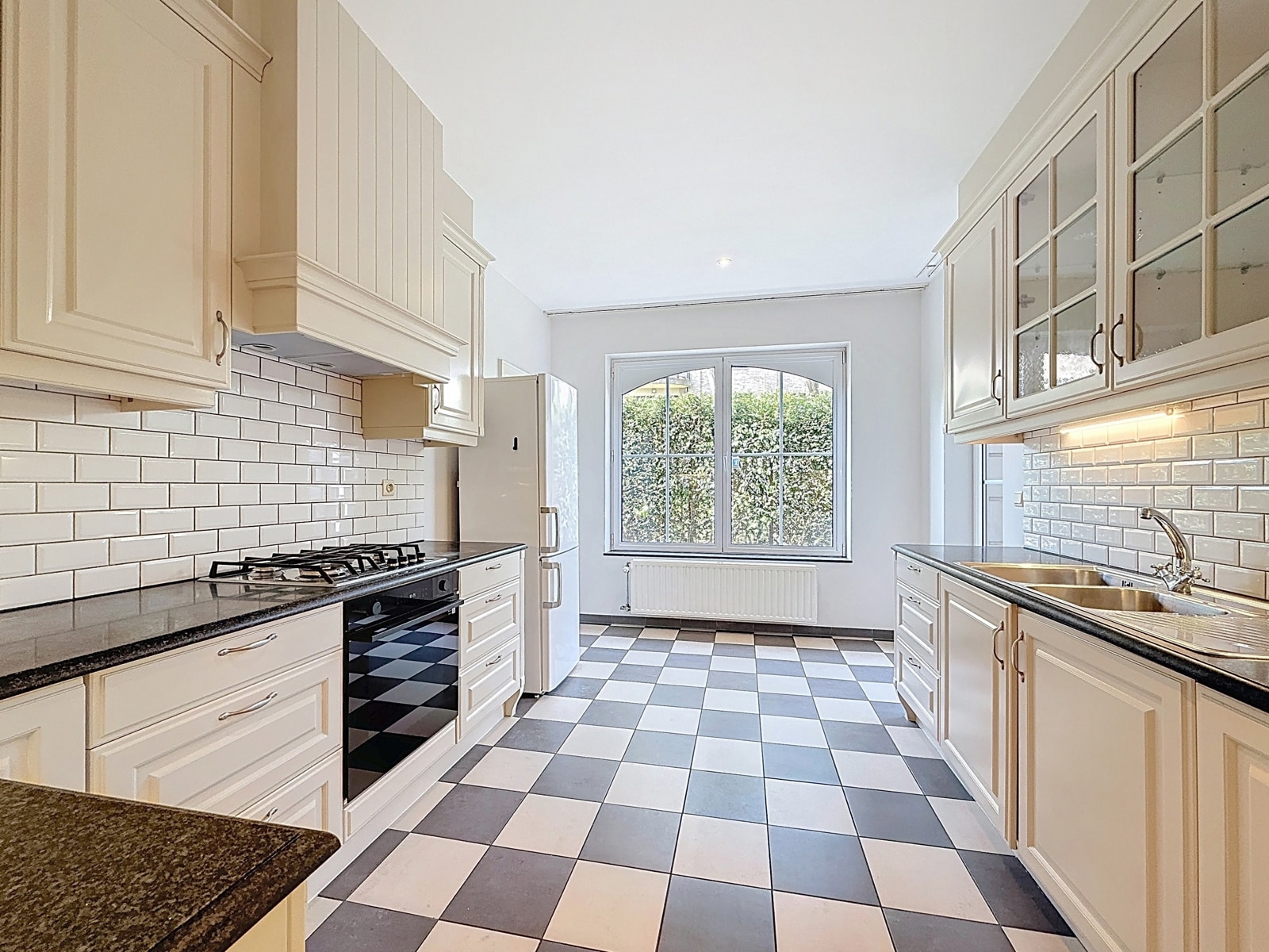 whise photo 7 Bright white kitchen with subway tile backsplash, granite counters, and a large window overlooking greenery
