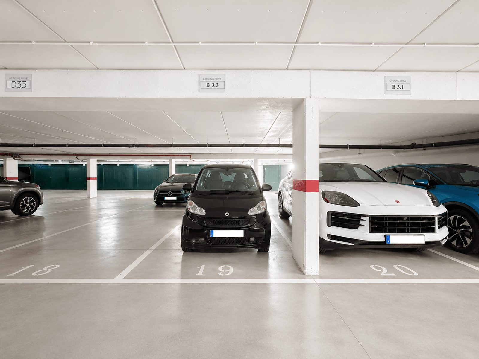 Secure underground parking lot - You Real Estate Agency Secure underground parking with private spaces and parking spots assigned to each apartment.