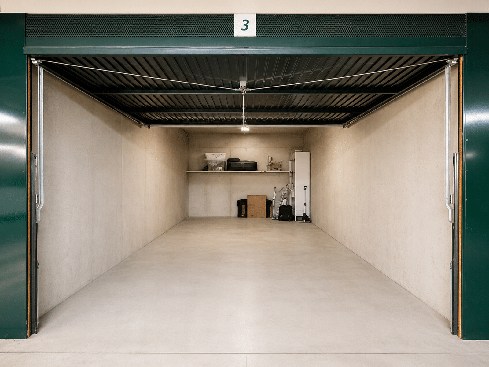 Spacious Private Garage – You Real Estate Agency Spacious, clean private garage with storage shelves.