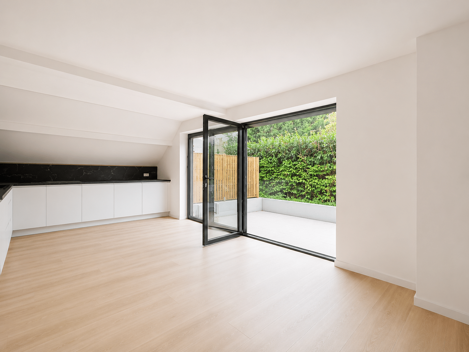 whise photo 3 Bright, minimalist kitchen with white cabinets, black granite backsplash, and large glass doors opening to a fenced patio.