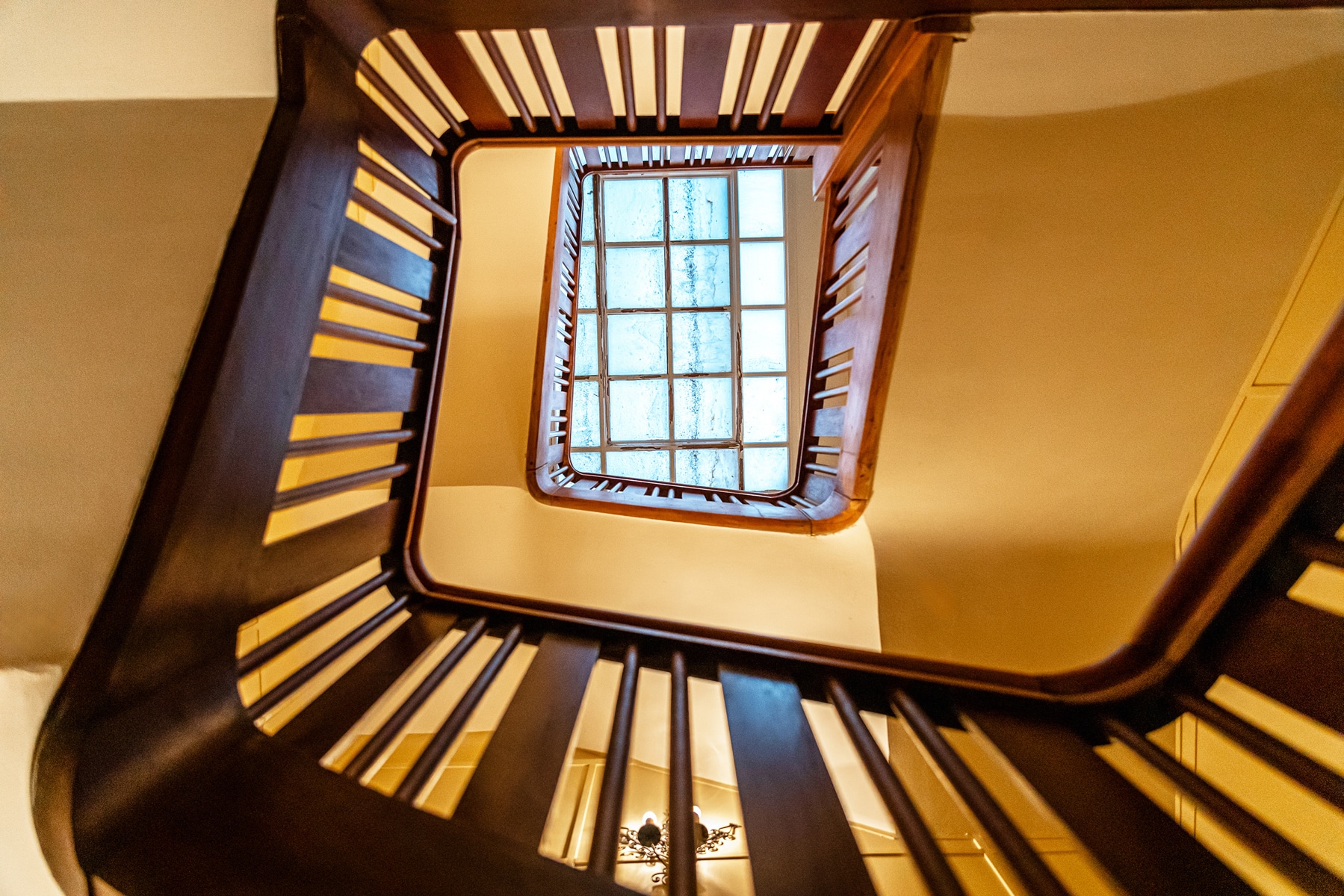 Stairwell with Skylight – You Real Estate Agency Elegant stairwell with a skylight in a residential building.