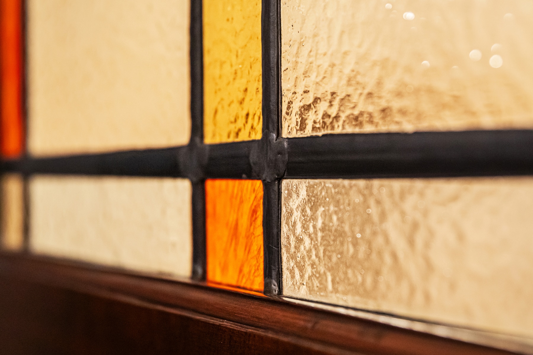 Decorative Amber Stained Glass – You Real Estate Agency A decorative stained-glass window made of amber glass that adds charm to a home.