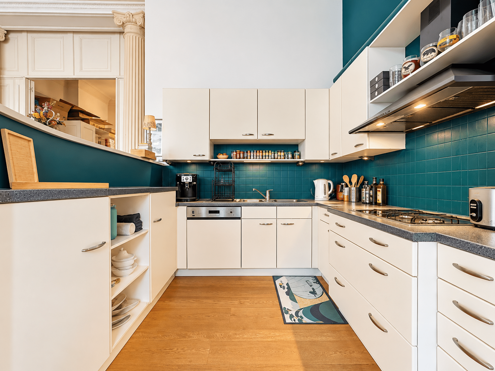 Cuisine Moderne Équipée – You Real Estate Agency Cuisine moderne équipée avec carrelage bleu, rangements blancs et plancher en bois.